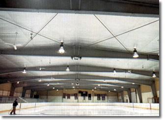 A large indoor arena with lights and fans.