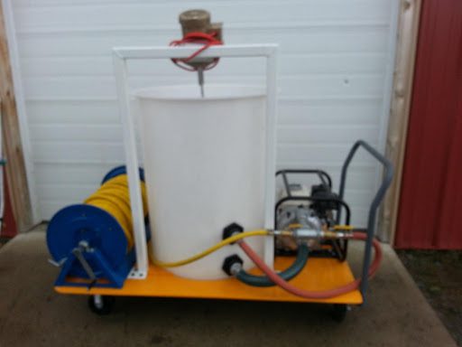 A cart with a hose attached to it and a tank on top.