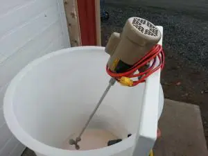 A bucket with a motor and some wires attached to it